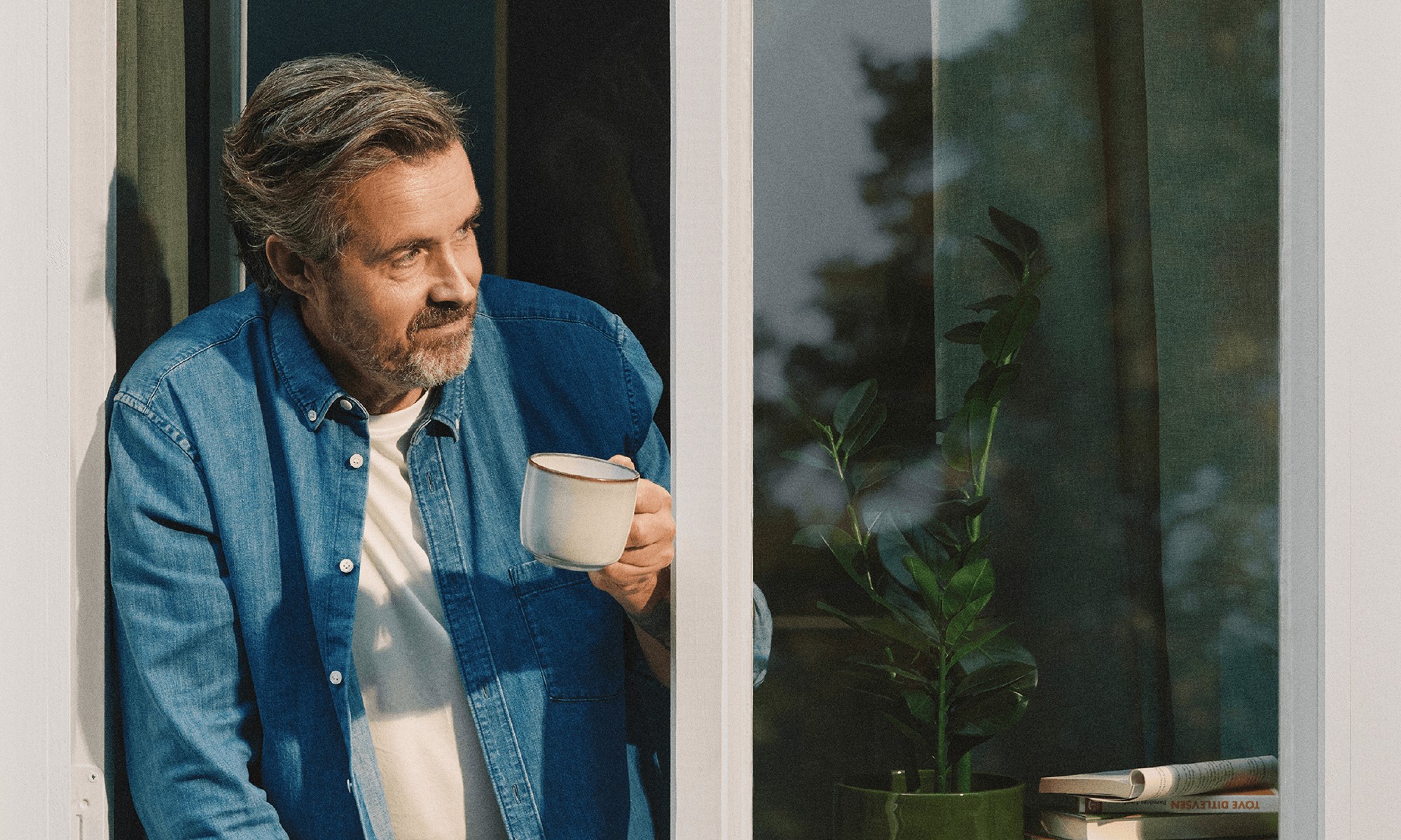 Man looking out from window